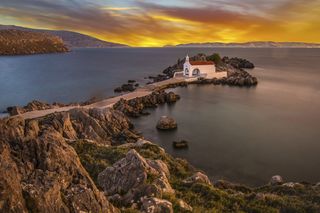 A church on a spit of land off the coast of Chios in Greece