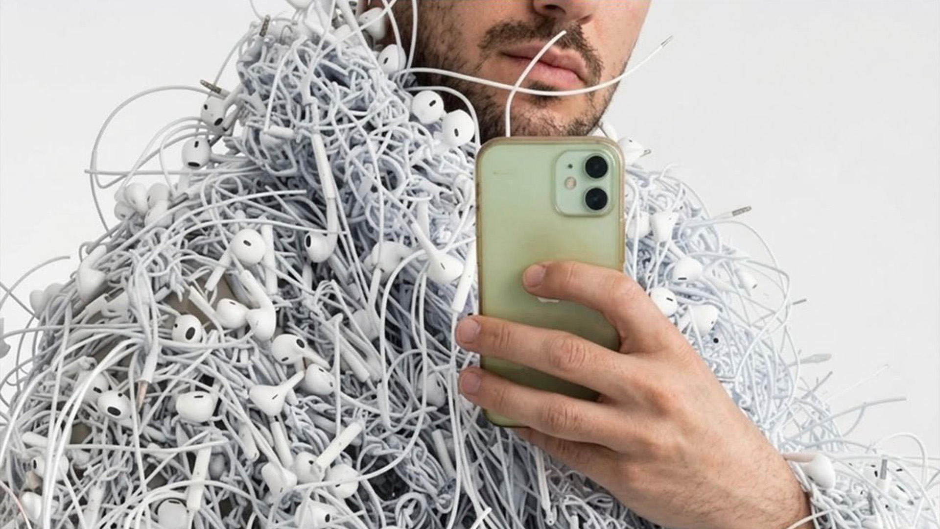 Apple social post featuring a man wearing a jacket made of tangled earbuds