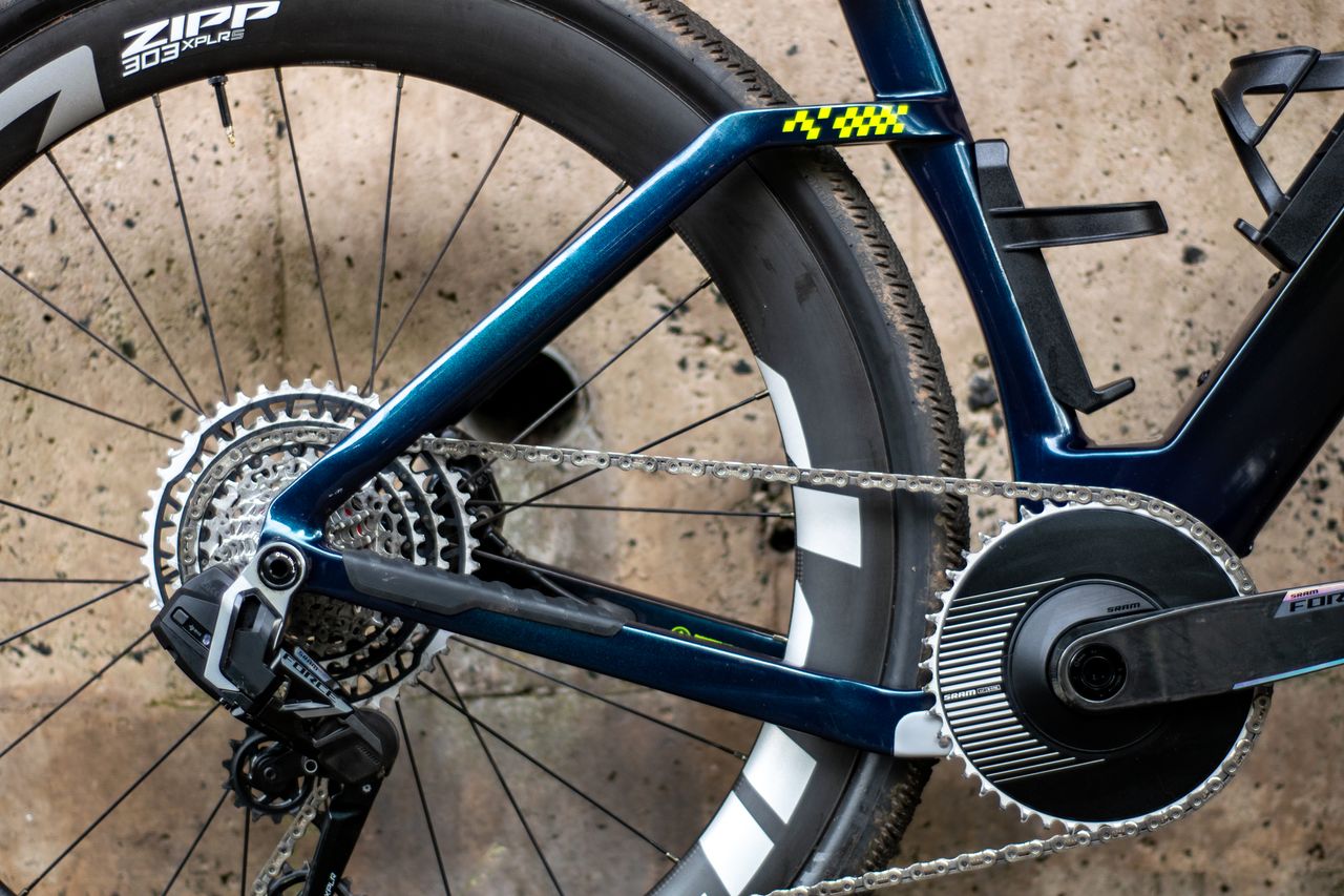An Argon 18 Anti Matter gravel bike leaning against a concrete wall.