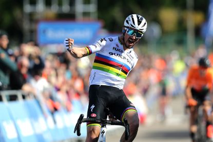 Julian Alaphilippe celebrating in the rainbow jersey