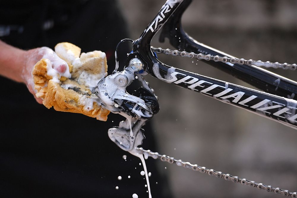 Quick-Step mechanics wash the bikes after a training ride