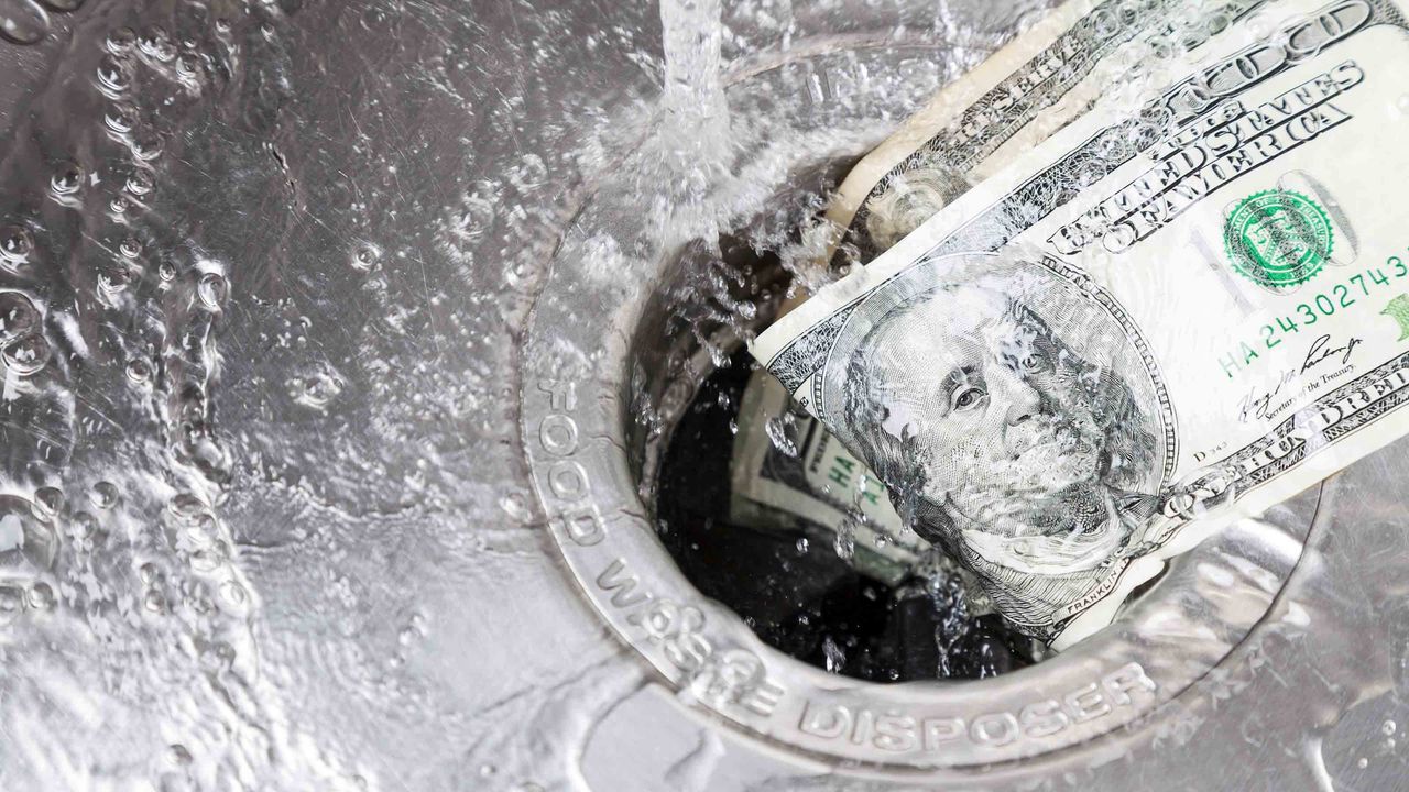 Dollars going down a garbage disposal