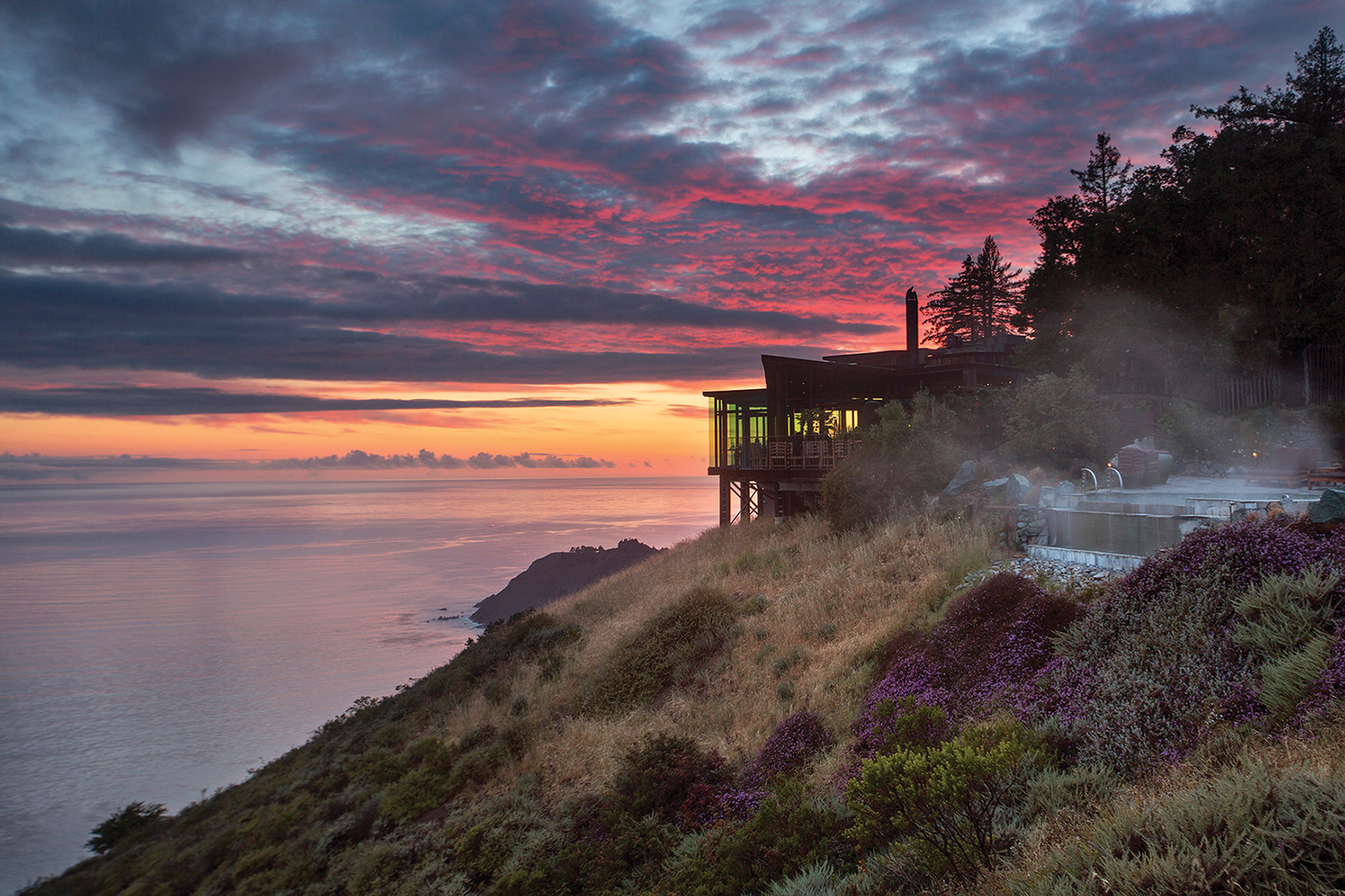 A view of the hotel with a sunset beyond.