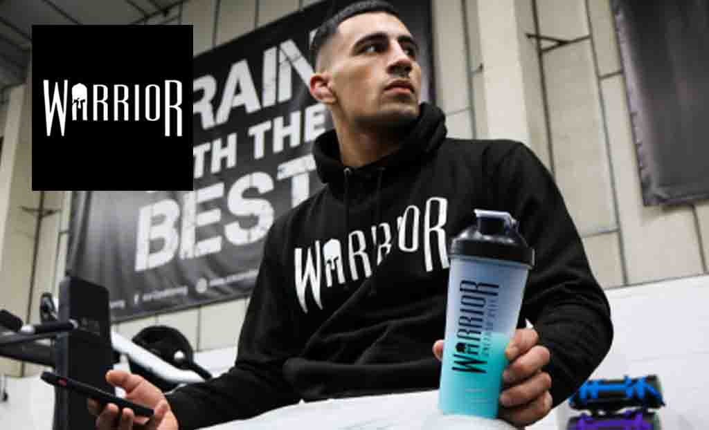 Warrior logo placed over an image of a low shot of a guy wearing a warrior hoodie and holdinh a warrior protein shaker