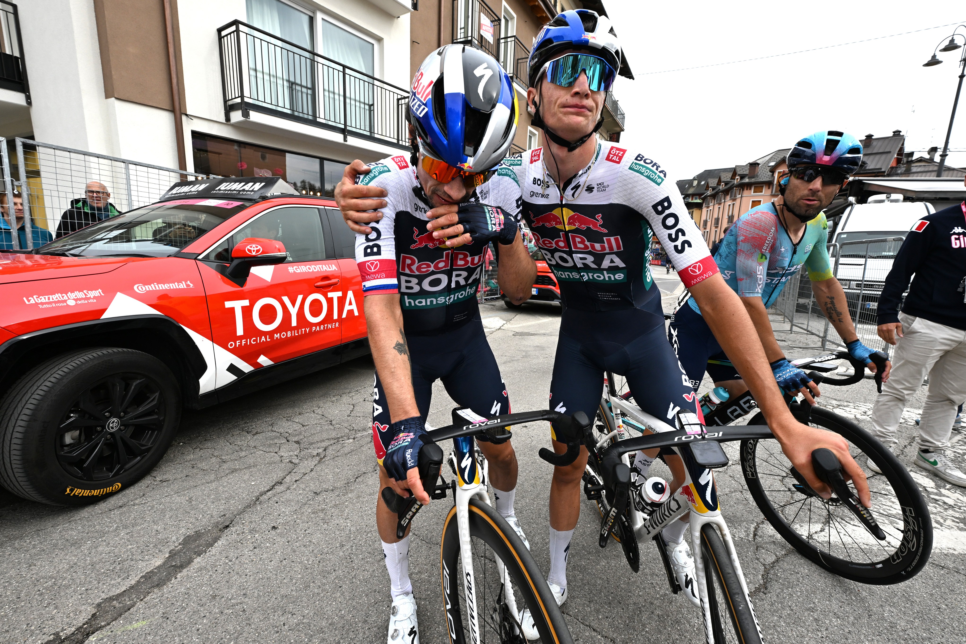 Primoz Roglic hugged by a teammate at the Giro d&#039;Italia