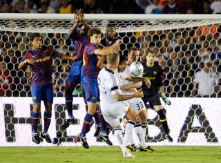 David Beckham scores a free-kick for LA Galaxy in a friendly against Barcelona in 2009.