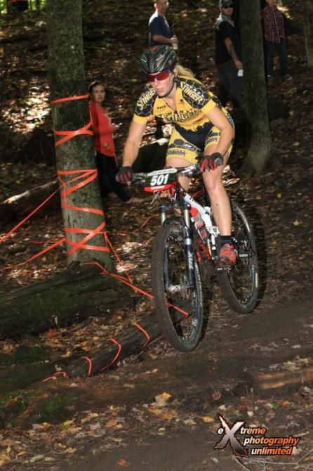 Abby Strigel (Honey Stinger/Bontrager) takes a log jump with ease
