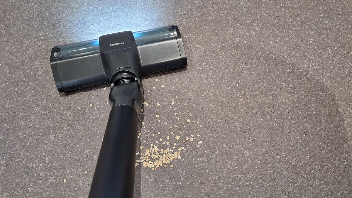 Oats pooled behind Samsung Bespoke AI Jet Ultra floorhead on lino