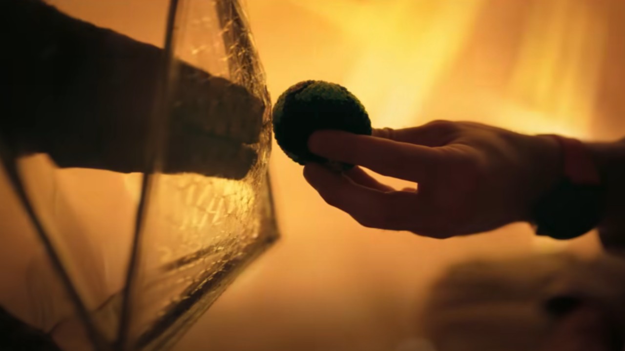 From left to right: Rocky touching an Earth beanbag that Ryland is holding out.