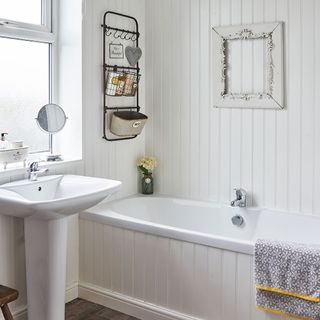 bathroom with bathtub and white walls