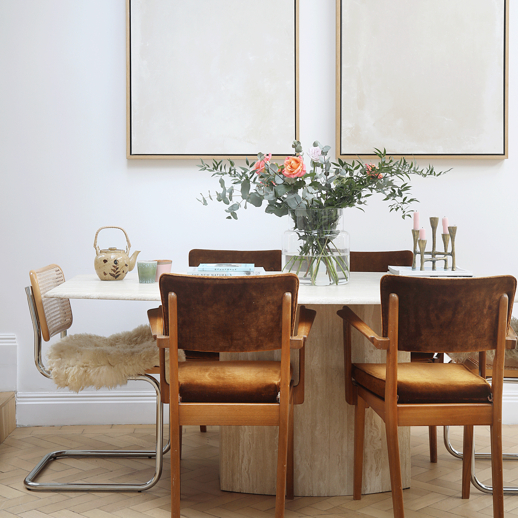 a dining area with a neutral dining table and chairs