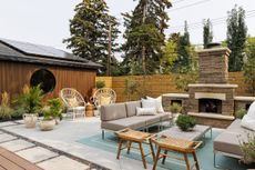 a backyard with an outdoor fireplace