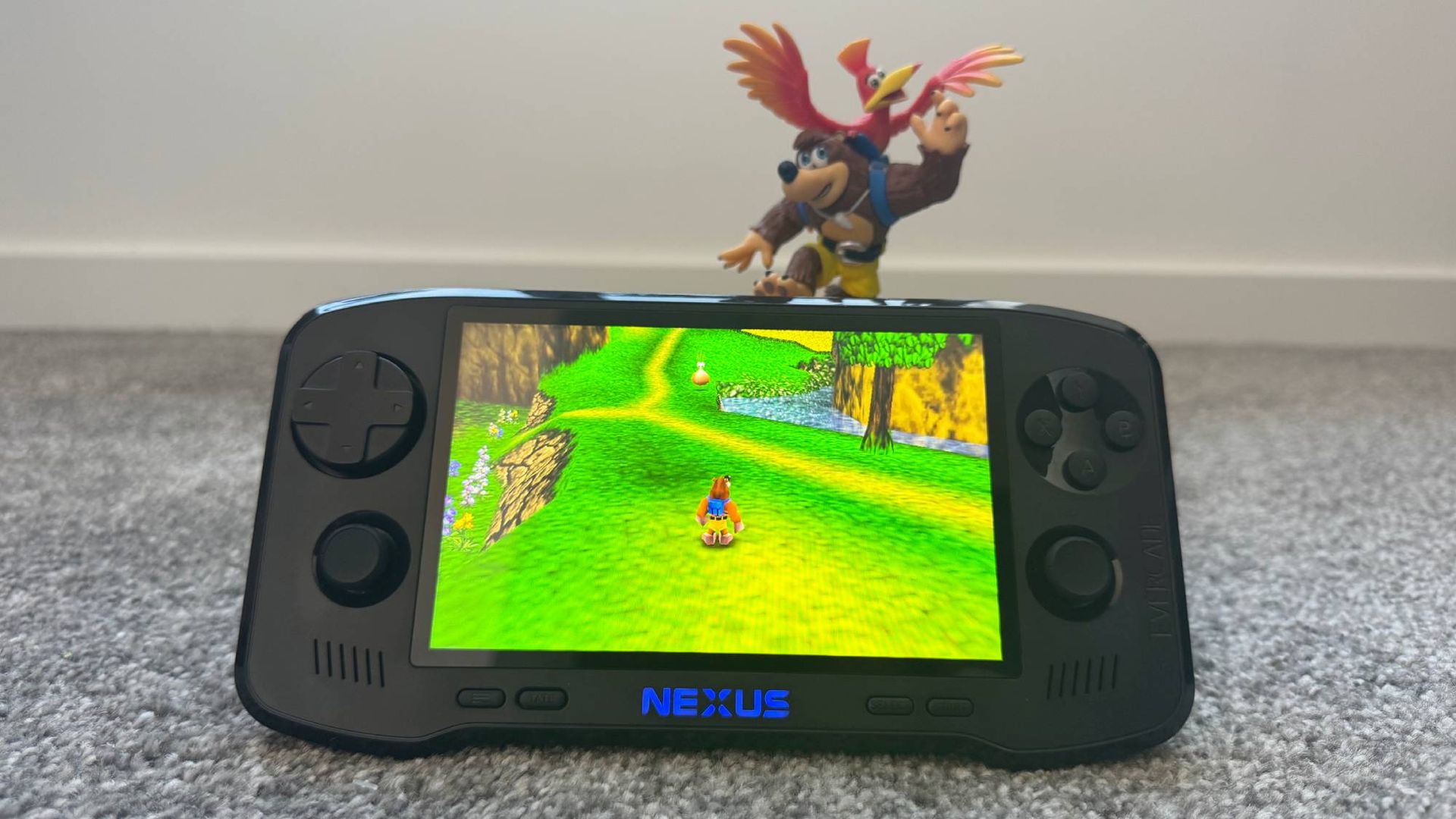 Evercade Nexus playing Banjo-Kazooie in front of a Banjo-Kazooie Amiibo