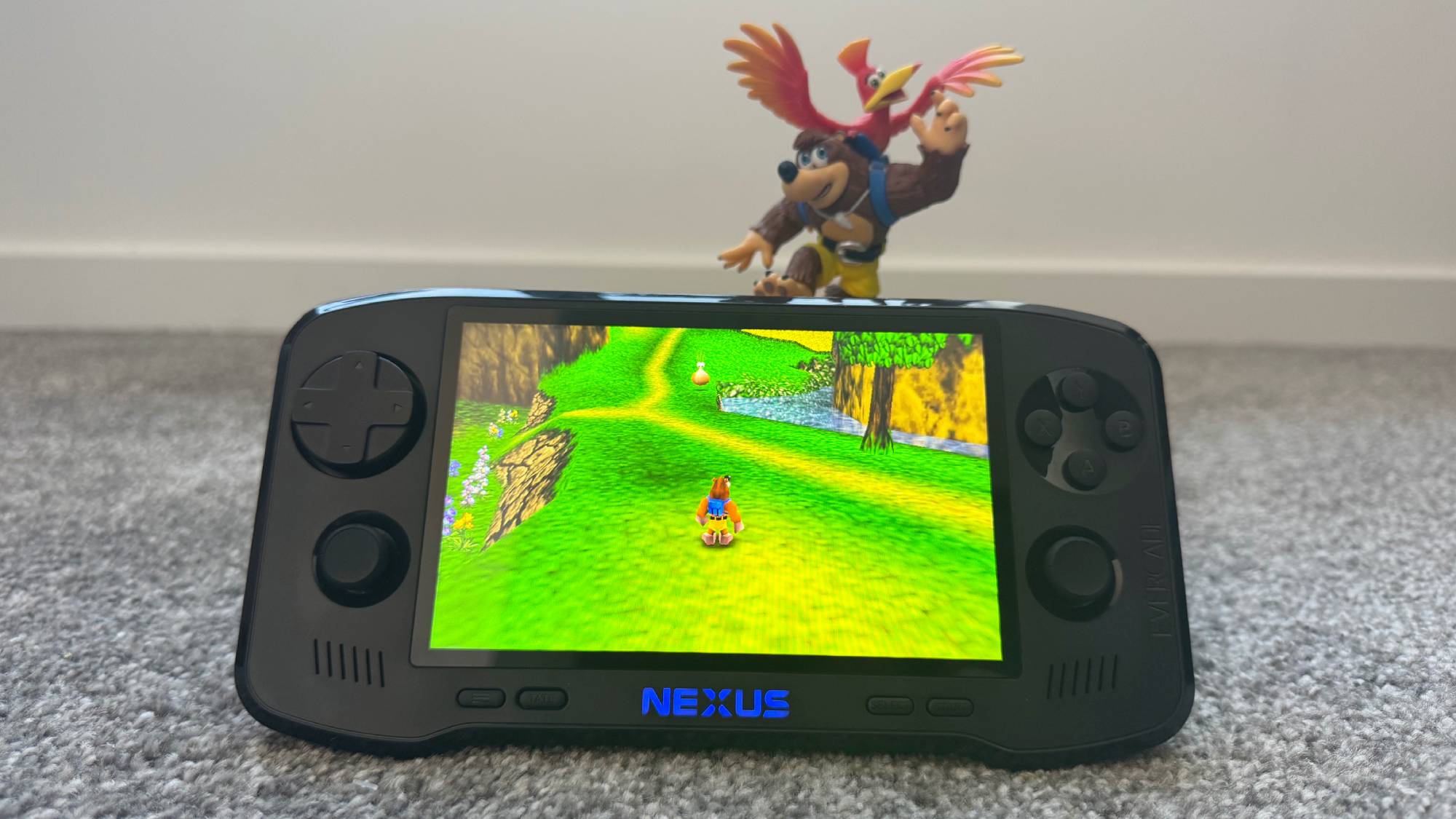 Evercade Nexus playing Banjo-Kazooie in front of a Banjo-Kazooie Amiibo