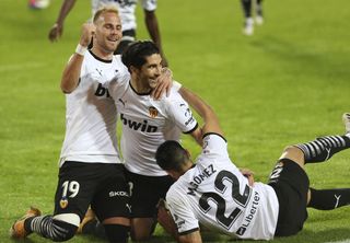Carlos Soler, centre, was the hero for Valencia with three goals from the penalty spot against Real Madrid