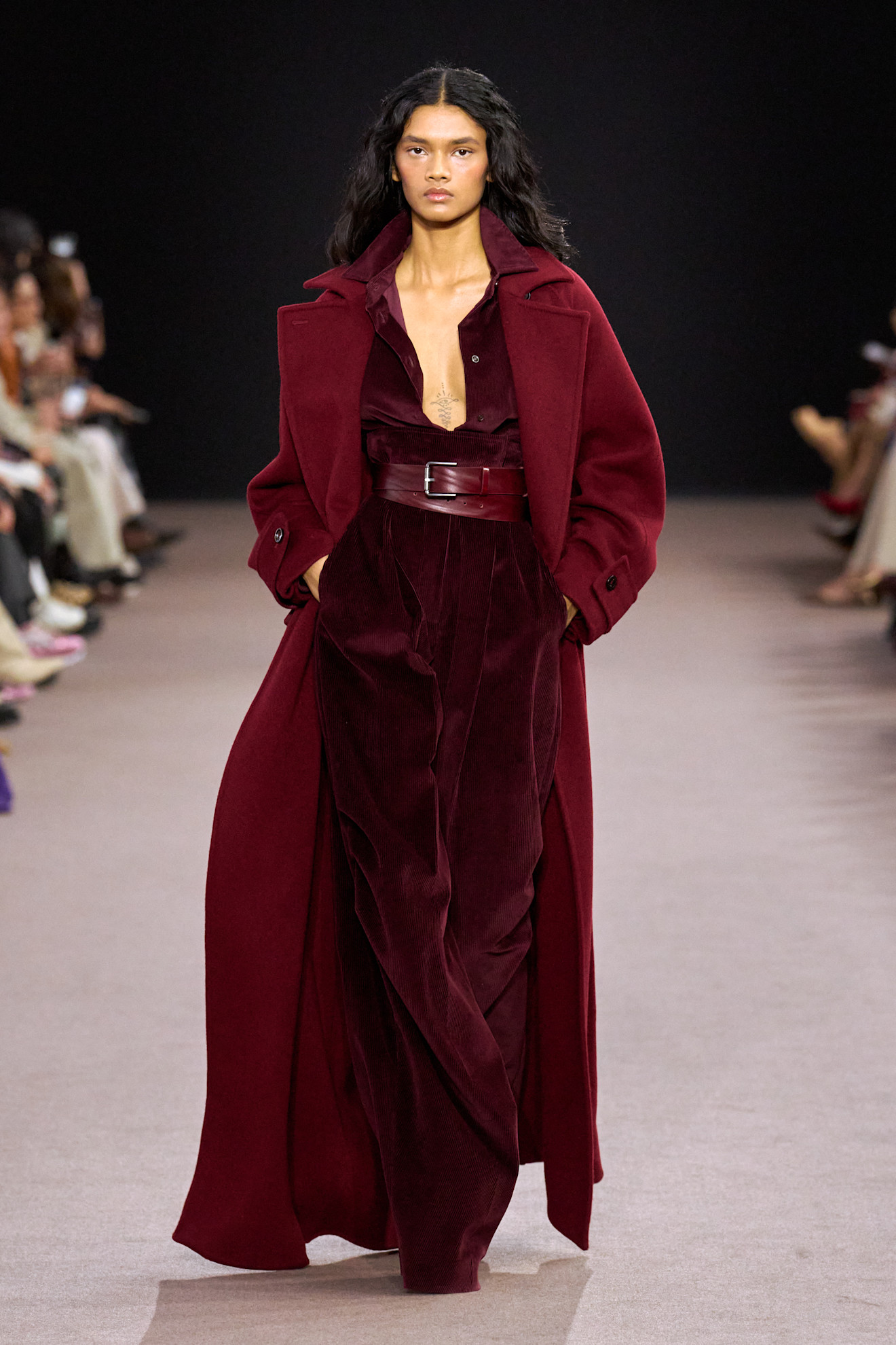 A model wears a burgundy coat, trousers, belt and shoes on the Max Mara autumn/winter 2025 runway