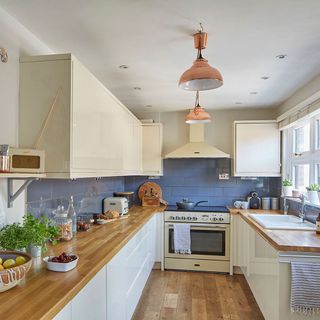 eighties house in oxfordshire exterior kitchen with wooden beam storage units oven
