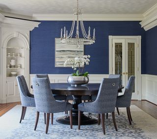 blue and white New England style dining room with chandelier
