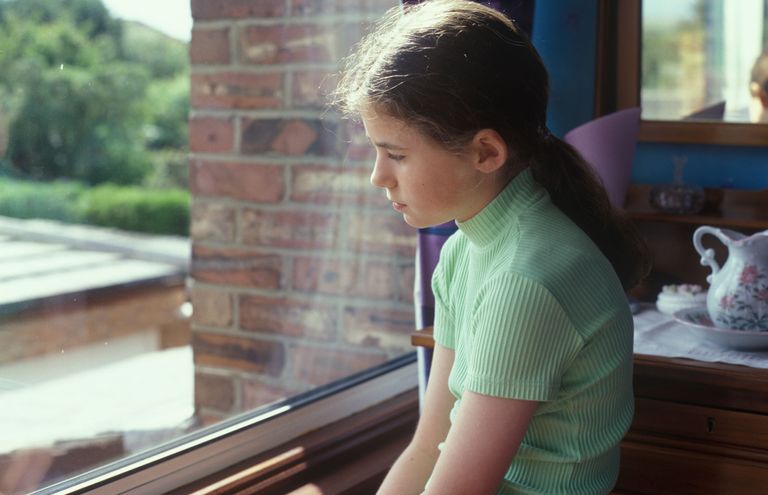 A bullied child looking out of the window