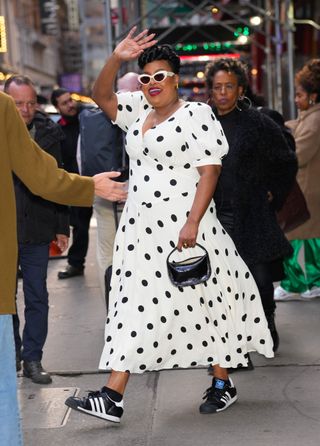 Natasha Rothwell wears a polka dot dress by Reformation