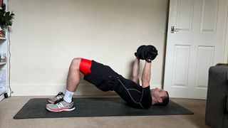 James Frew performing a dumbbell glute bridge