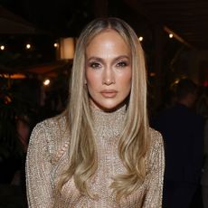 Jennifer Lopez wears a Tom Ford gown and fur coat