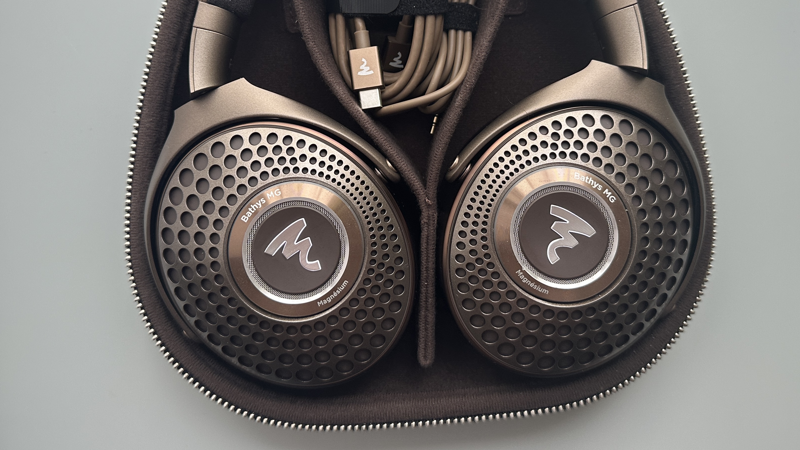 Focal Bathys Mg in bronze, featuring ear cup detail on gray background