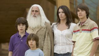 A still from the movie Evan Almighty in which the main characters all stand huddled together looking confused.