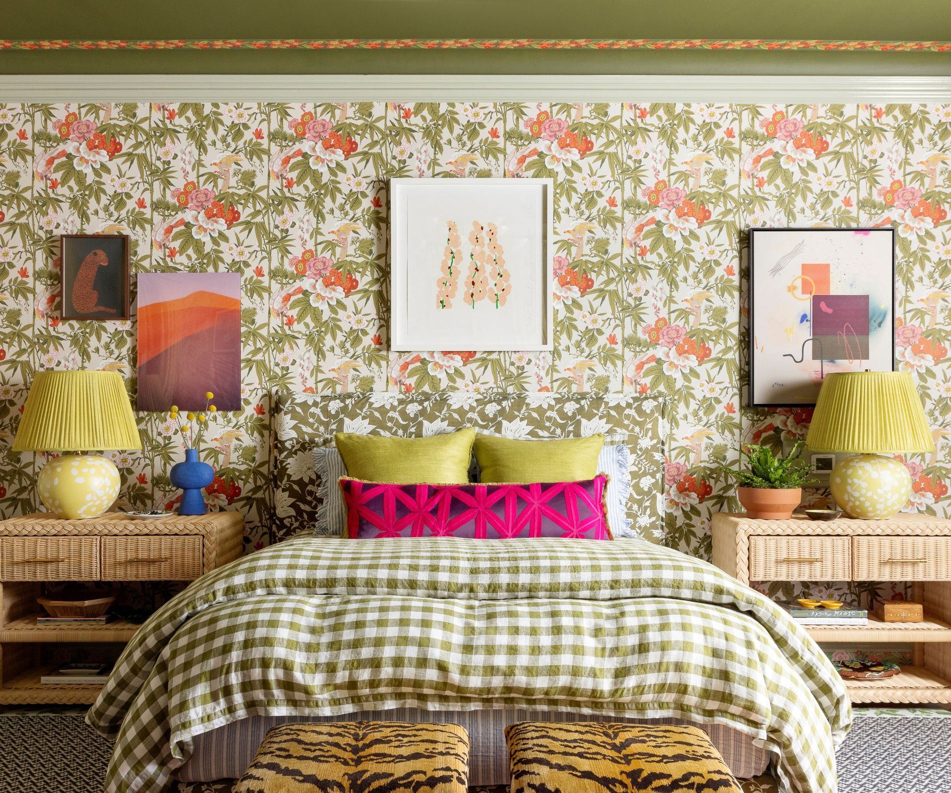 Eclectic bedroom with a patterned wallpaper, mis-matched artworks and chequered bedsheets