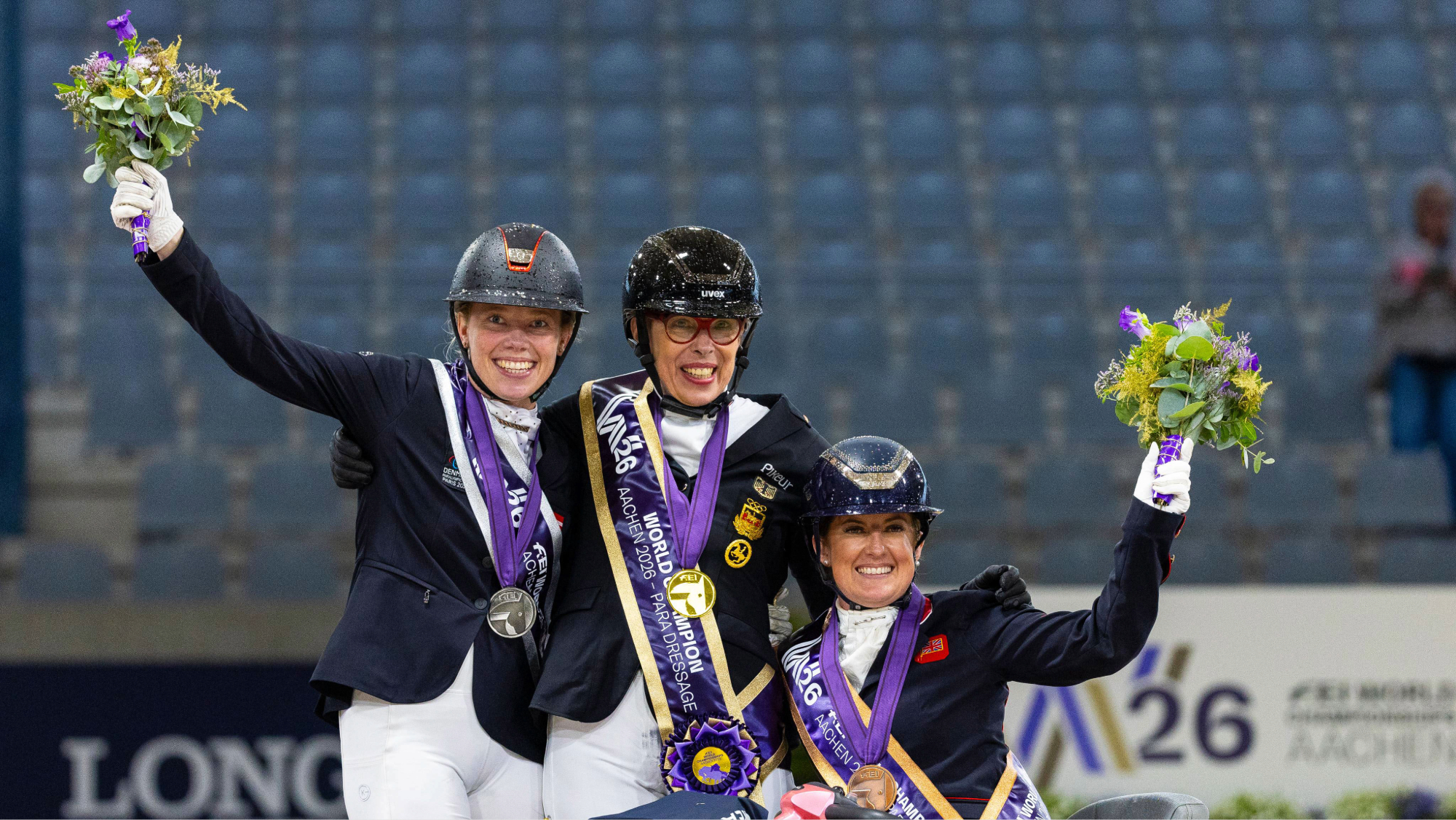 Heidemarie Dresing, Katrine Kristensen and Jemima Green with their medals on the podium at the 2026 World Para Dressage Championships in Aachen.