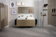 bathroom design with double sink and shower alcove