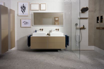bathroom design with double sink and shower alcove