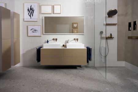 bathroom design with double sink and shower alcove