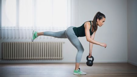 a photo of a woman performing a kettlebell single leg deadlift