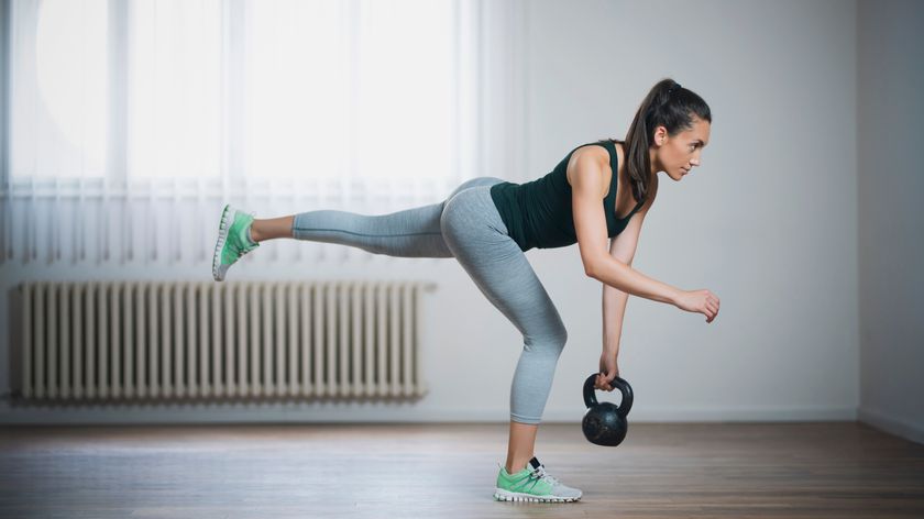 a photo of a woman performing a kettlebell single leg deadlift