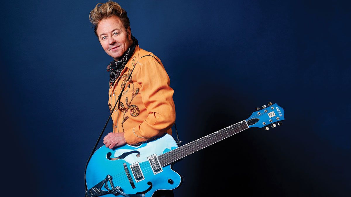 Brian Setzer poses with a Gretsch electric guitar