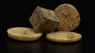 Roman (lead) die (bone) gaming pieced uncovered during the archaeology excavation at Blackgrounds, Chipping Warden