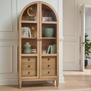 An arched wooden china cabinet from Wayfair
