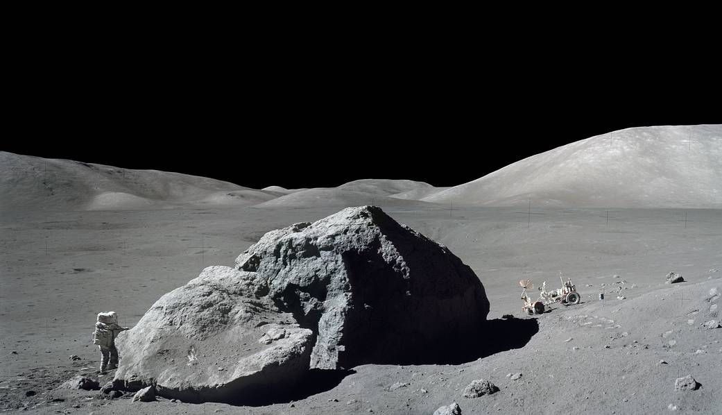 On Dec. 13, 1972, scientist-astronaut Harrison Schmitt is photographed standing next to a huge boulder during the final Apollo moon-landing mission, Apollo 17. This mosaic is made from two photos shot by fellow Apollo 17 moonwalker Eugene Cernan.