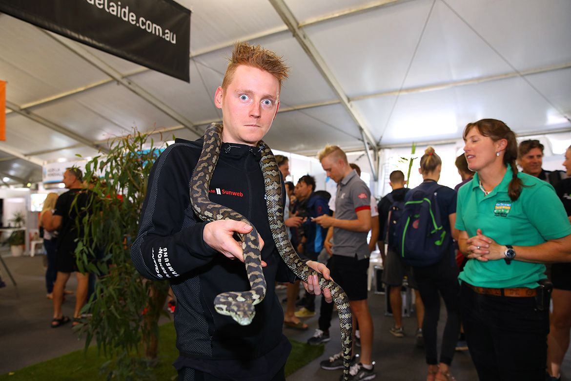 Sam Oomen with a snake around his neck at the Tour Down Under.