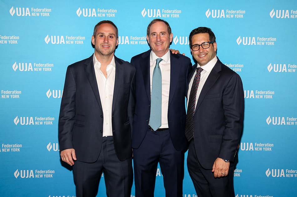 At the UJA-Federation of New York’s “Sports for  Youth Annual Luncheon” at Gotham Hall (l. to r.): Michael Rubin, CEO, Fanatics; Gary Gertzog, president of business affairs, Fanatics, and winner of the David J. Stern Leadership Award; and event emcee Adam Schefter, ESPN NFL reporter.
