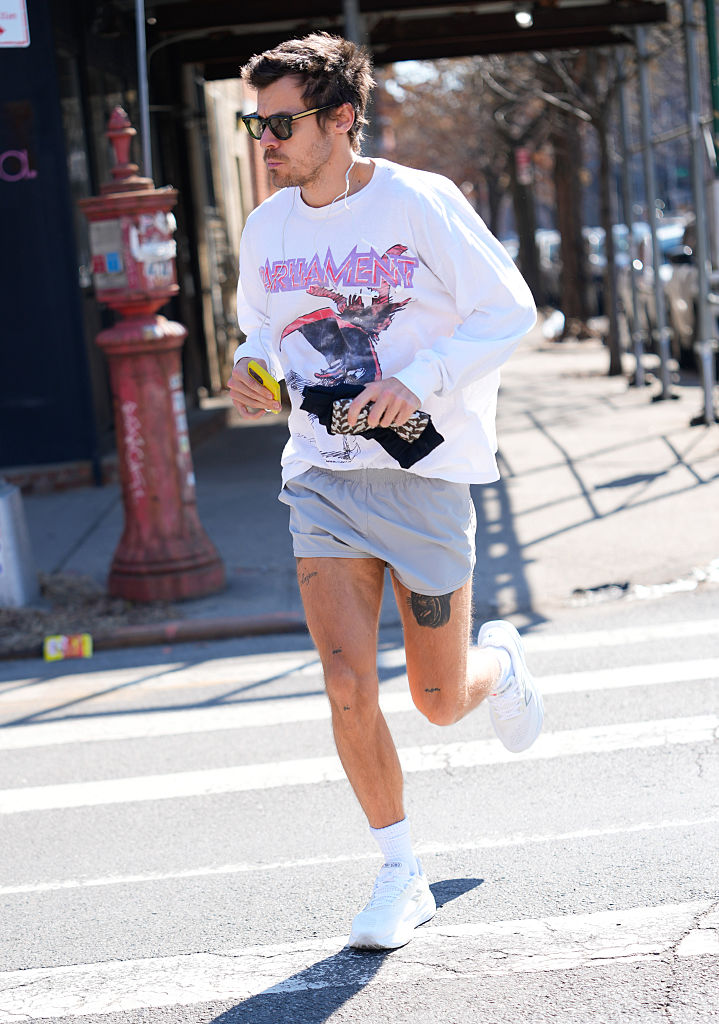 Harry Styles wears a band tee, shorts, and white trainers mens summer fashion 2026