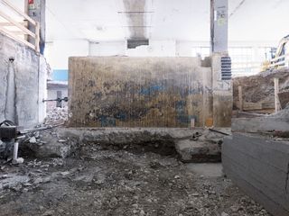 The basement workshop, pictured here with a revealed existing wall that is part of the foundation