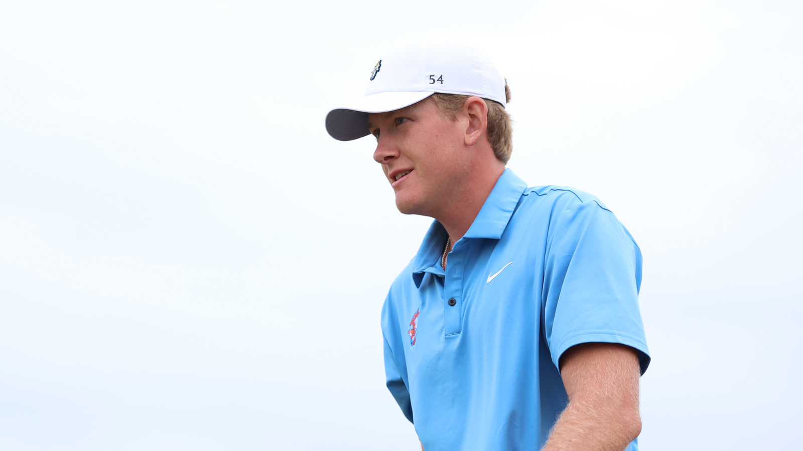 Luke Poulter reacts as he walks off the tee