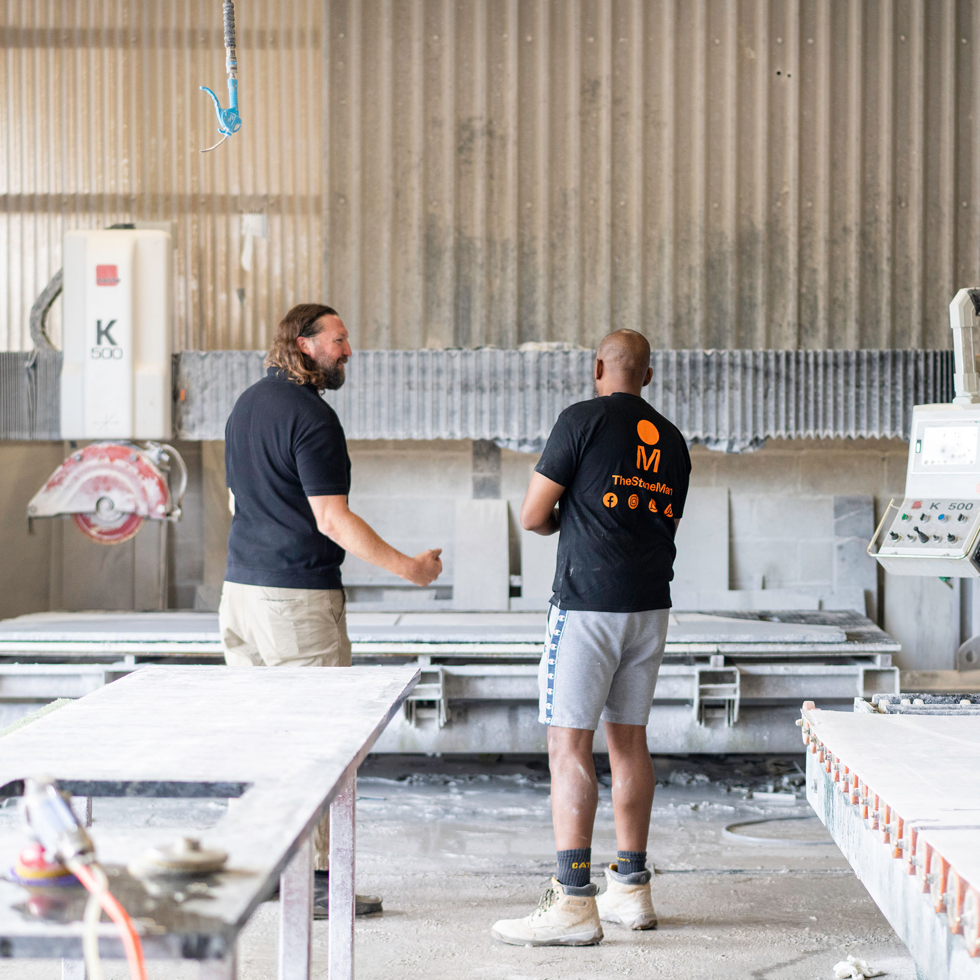 Two men standing in factory