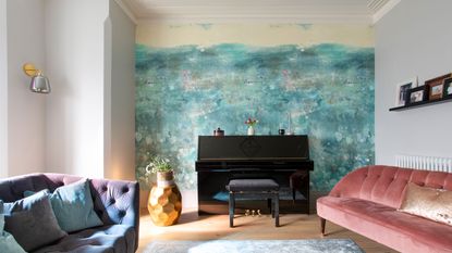 Living room with blue wallpapered chimney breast.