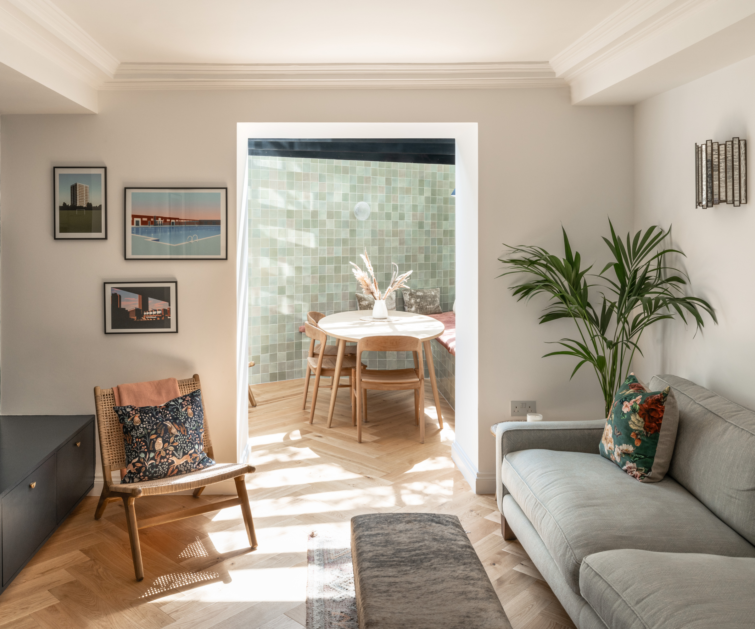view into dining room extension with tiled walls from living room