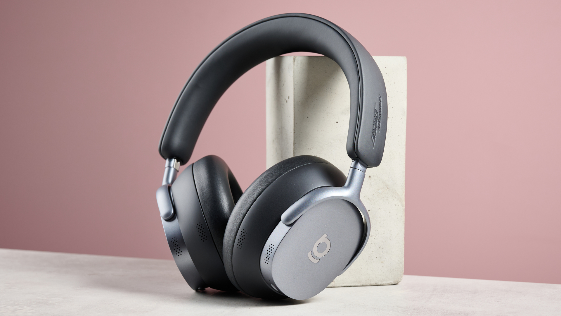 Baseus Inspire XH1 headphones against a pink background