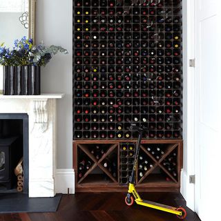 wine rack storage with flower on vase and fireplace