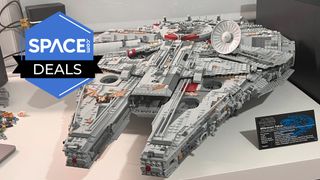 A Lego Star Wars UCS Millennium Falcon on a table, with plaque. 
